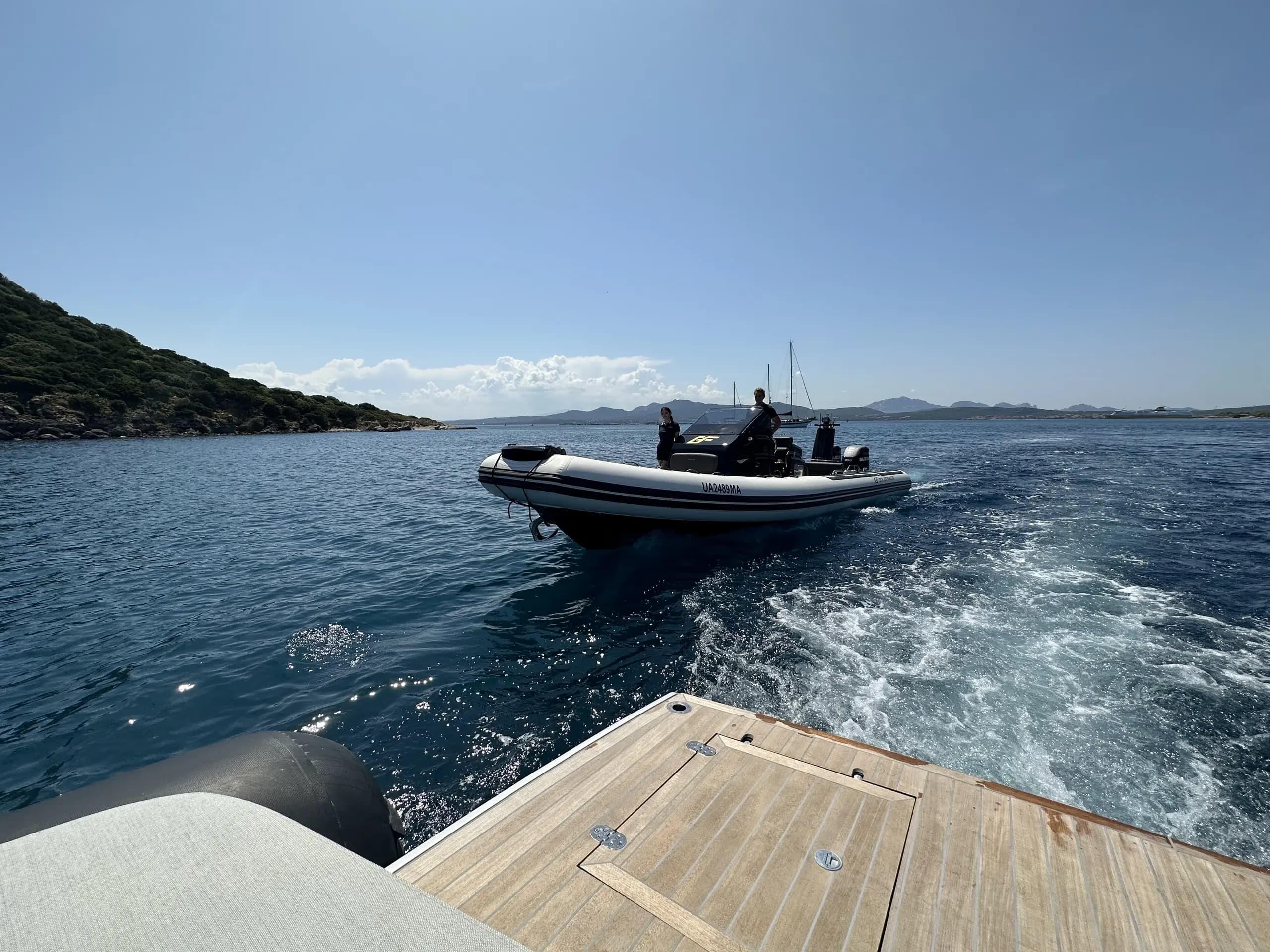 Brig Eagle 10 cruising alongside another boat with La Maddalena islands in the background