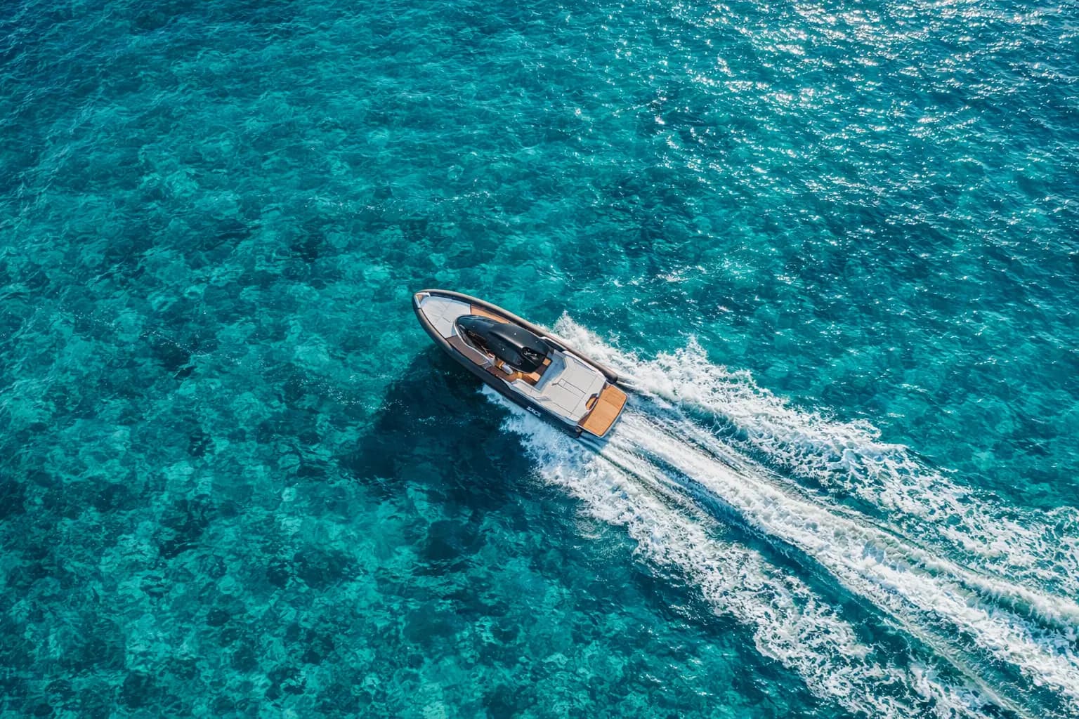Drone shot of SACS Strider 15 cruising at speed over turquoise Mediterranean sea