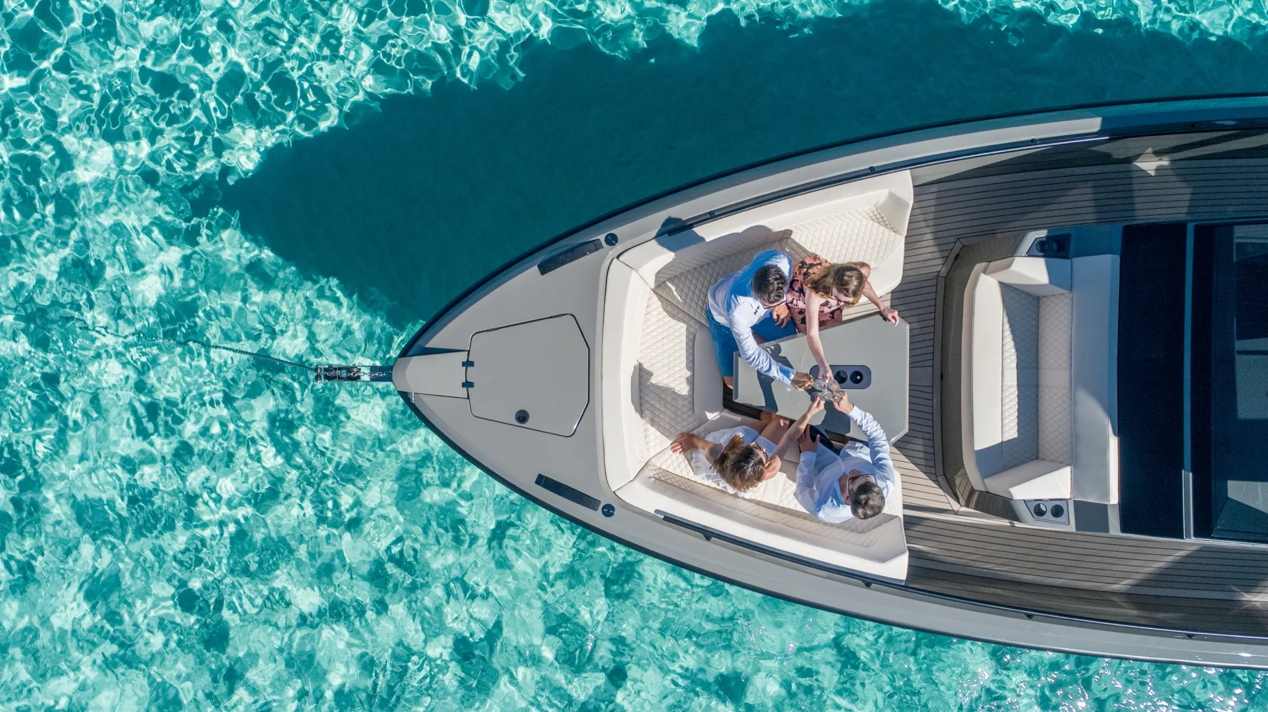 Guests enjoying lunch aboard Vanquish VQ40 in shallow turquoise bay