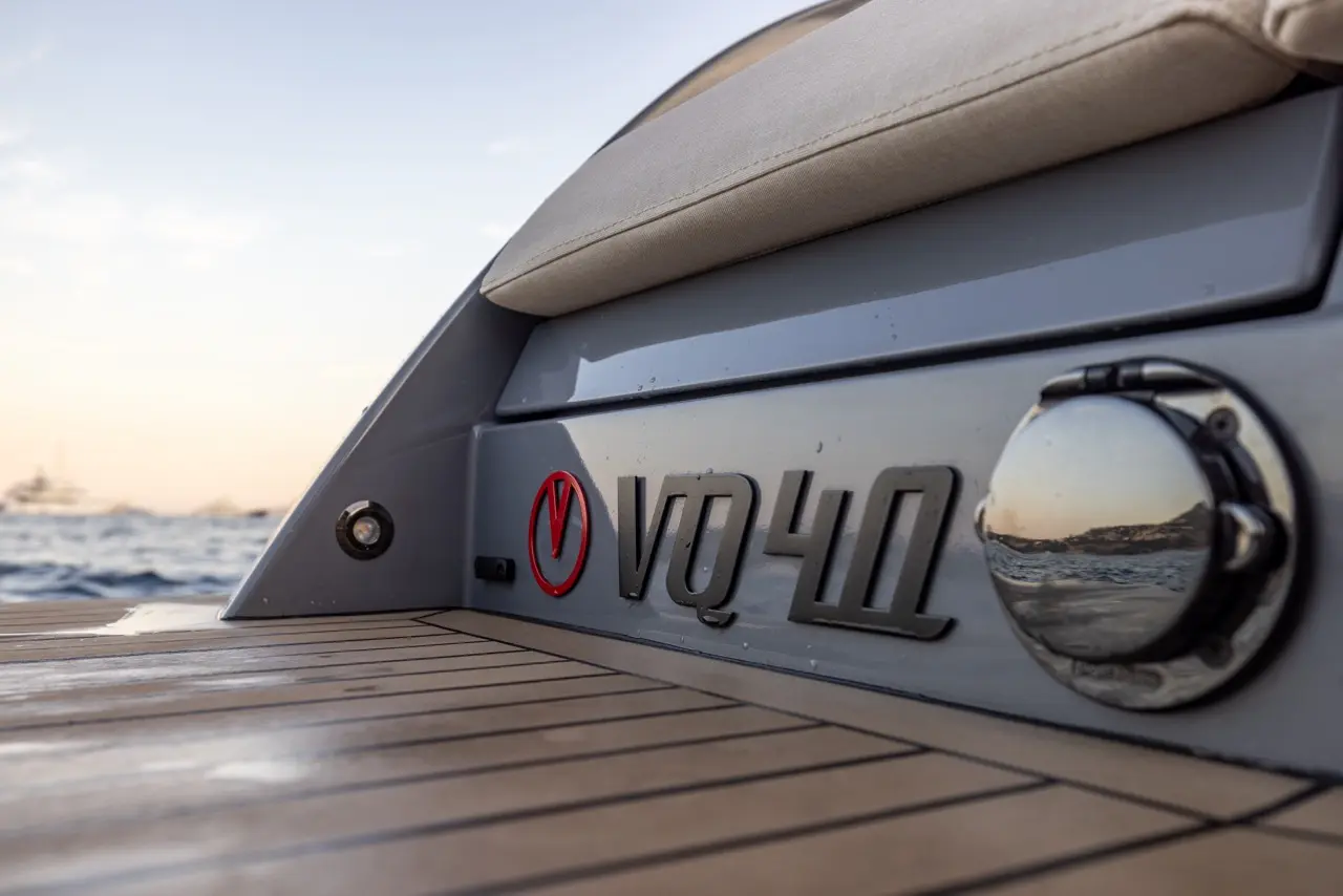 Vanquish VQ40 logo badge on hull with teak swim platform