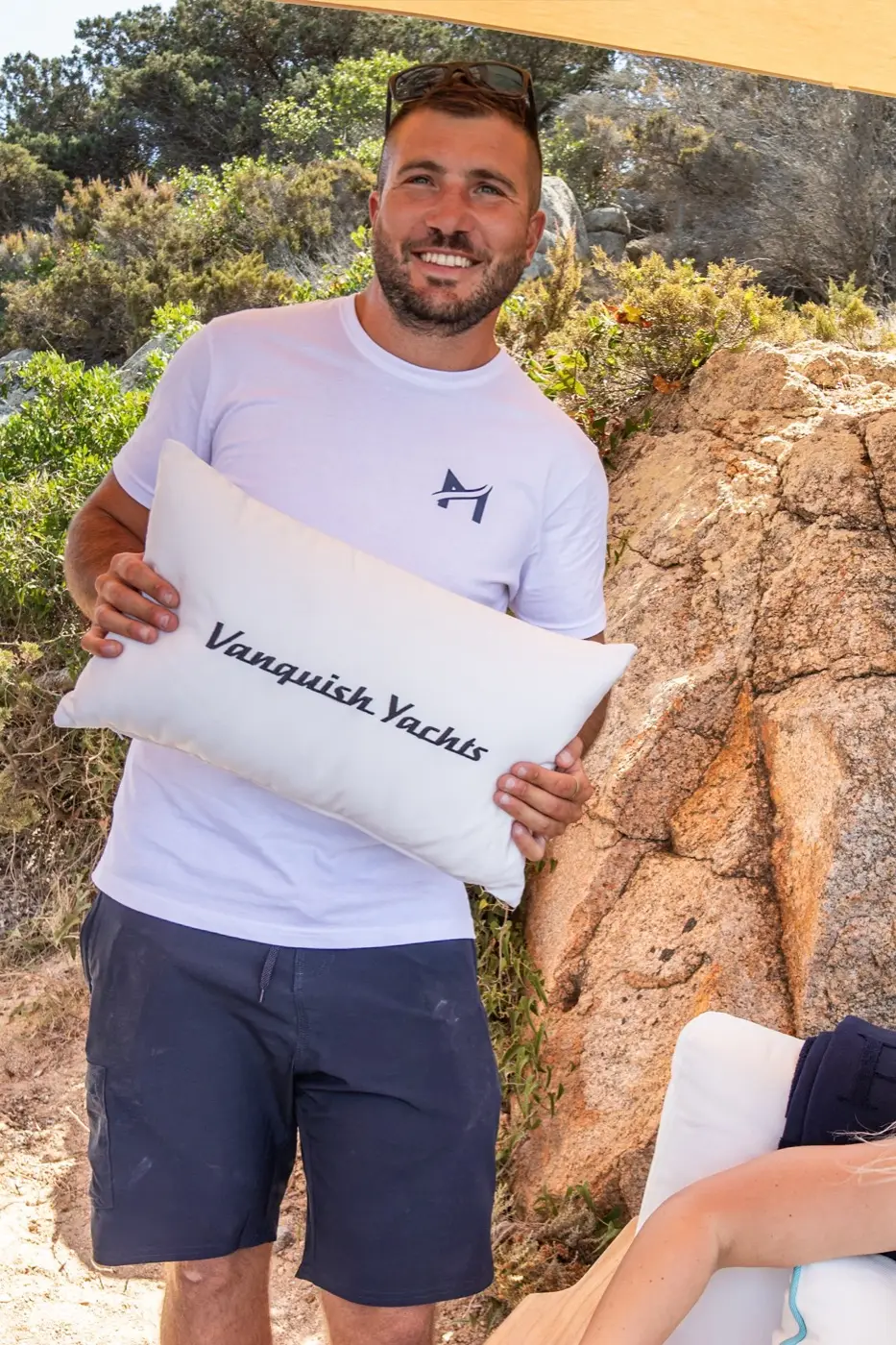 Carlo holding a Vanquish Yachts cushion on a MareFun boat in Sardinia