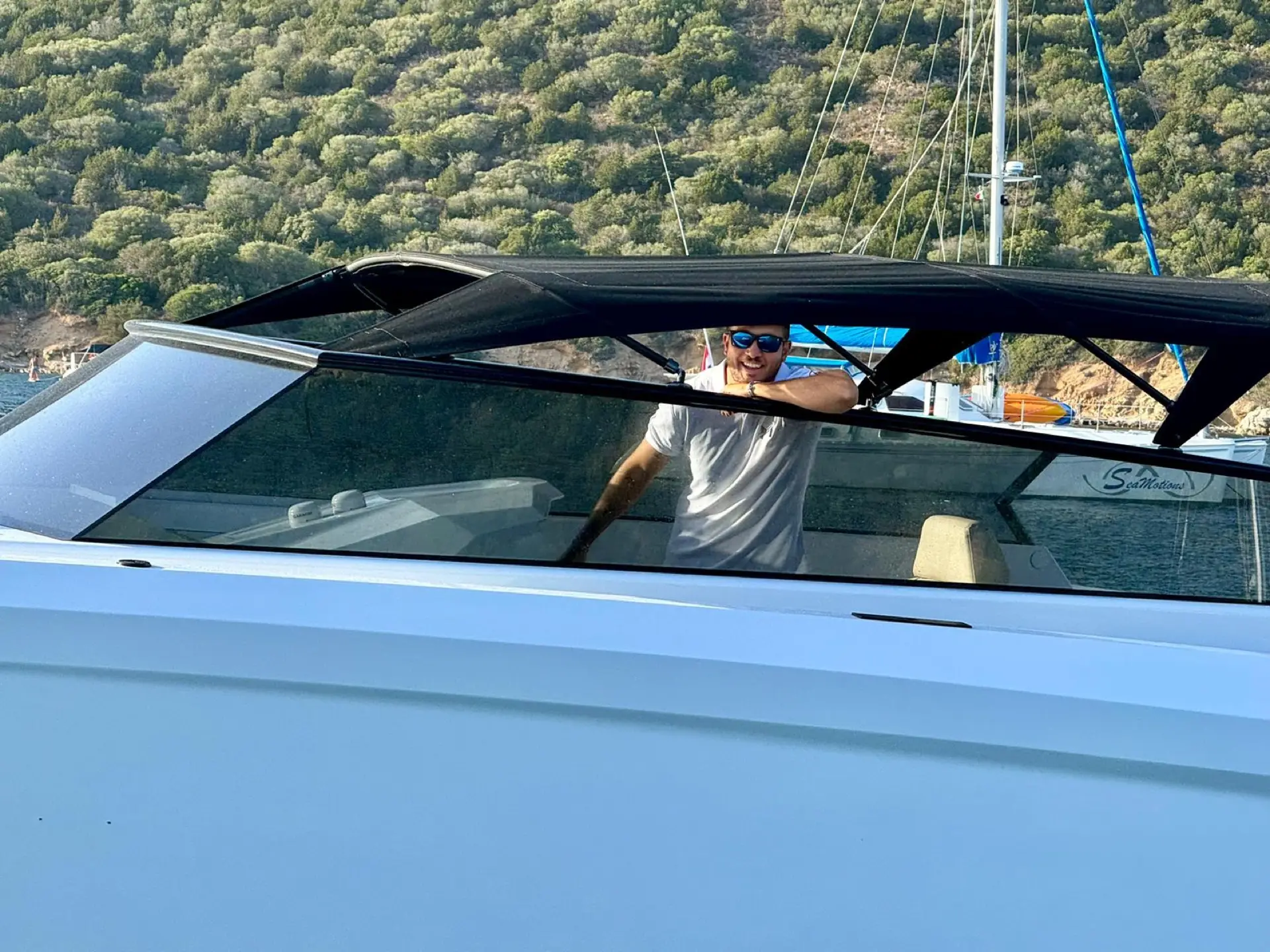 Carlo peering through the windshield of a MareFun charter yacht in Sardinia