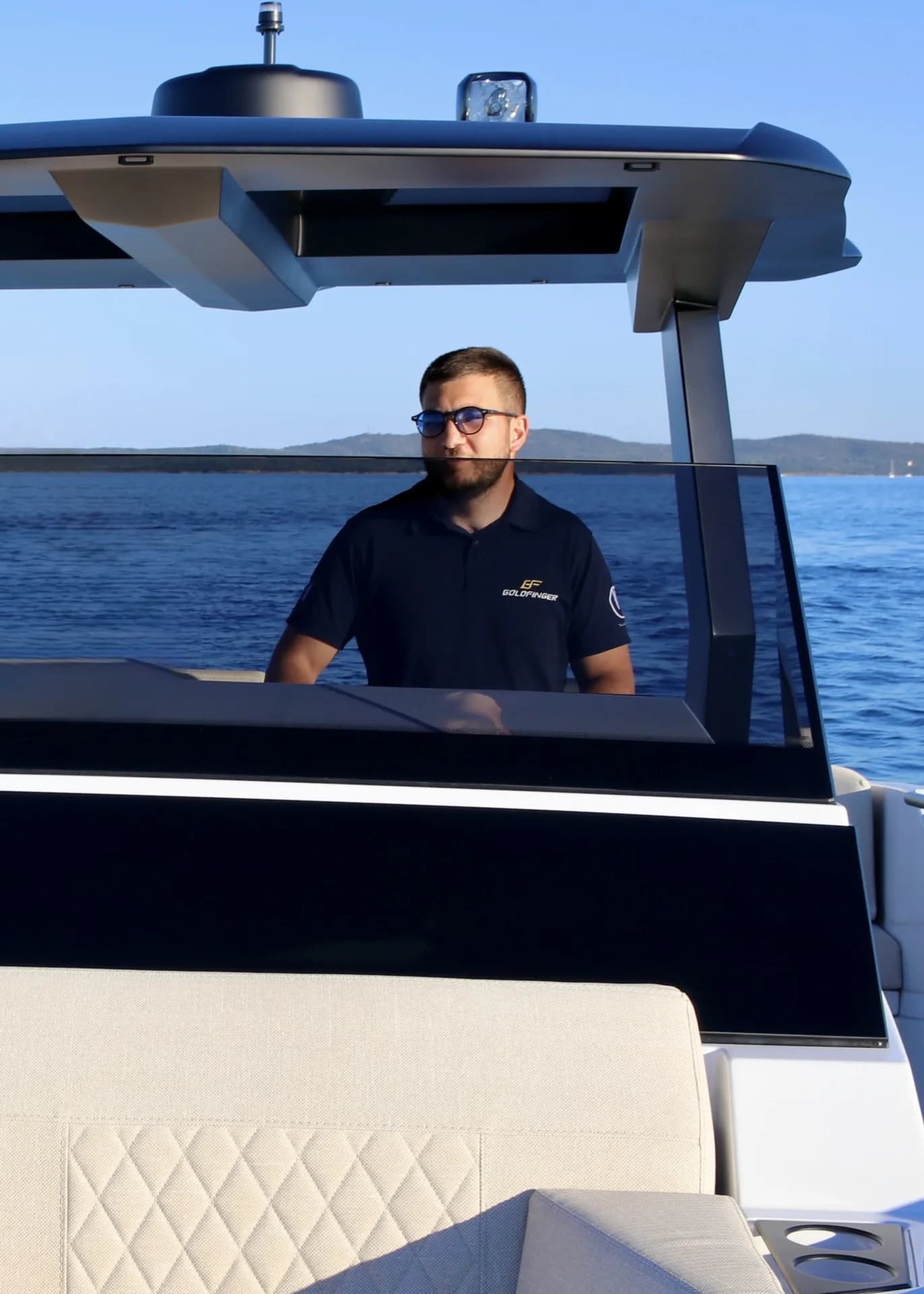 Carlo, professional skipper at MareFun, at the helm of a luxury yacht in Sardinia