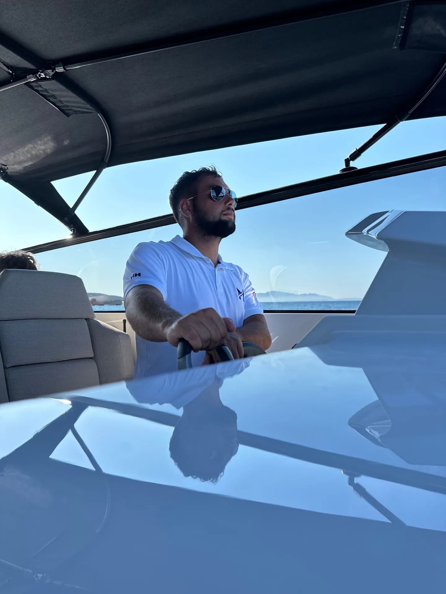 Lorenzo, MareFun captain, navigating through the waters off Sardinia