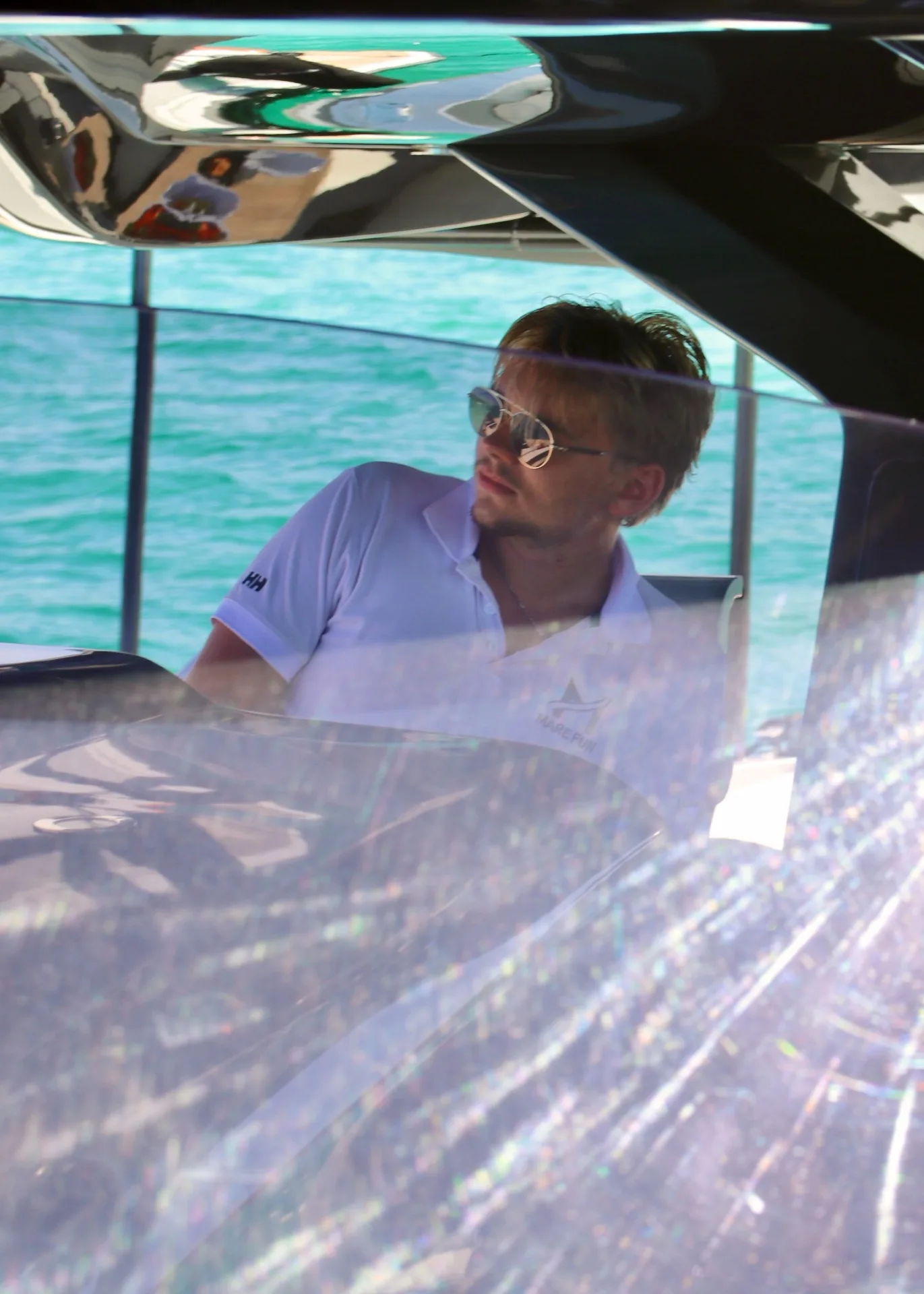 Valentijn piloting a MareFun charter boat through the turquoise Sardinian waters
